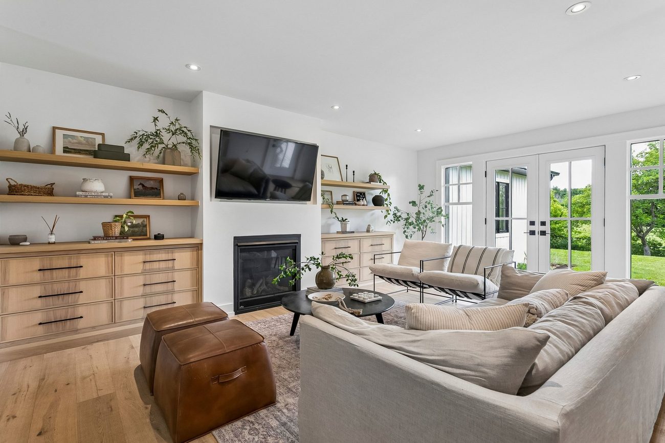Living room with fireplace and built-in oak shelving
